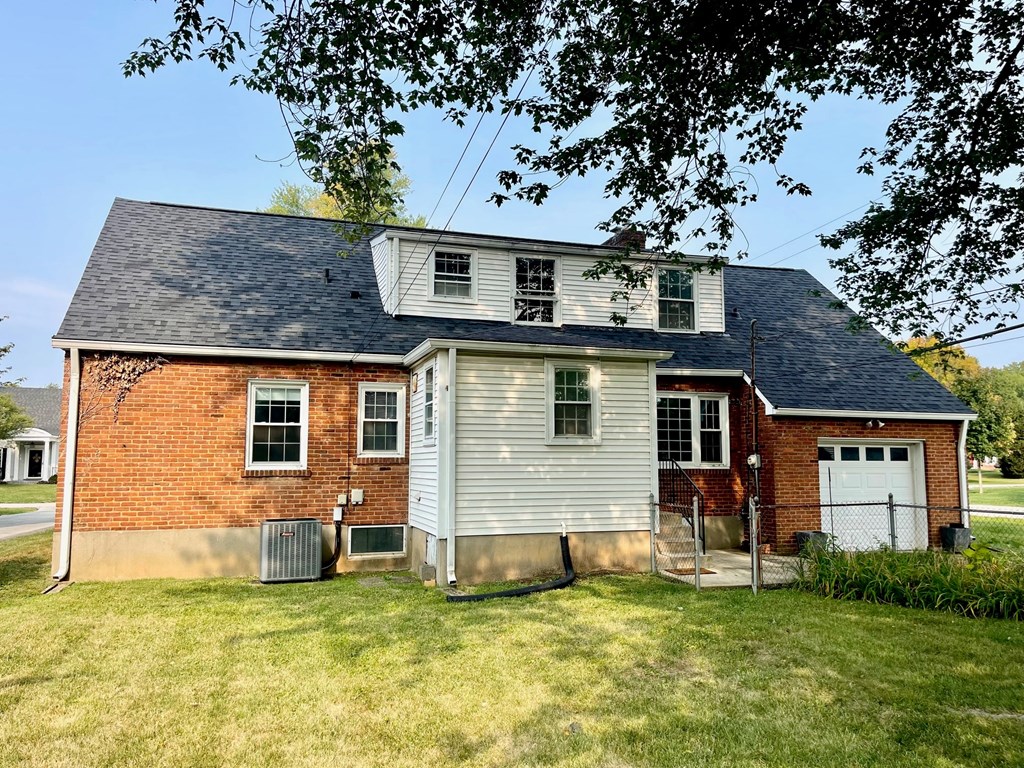 A two-story house with a garage on the right side.