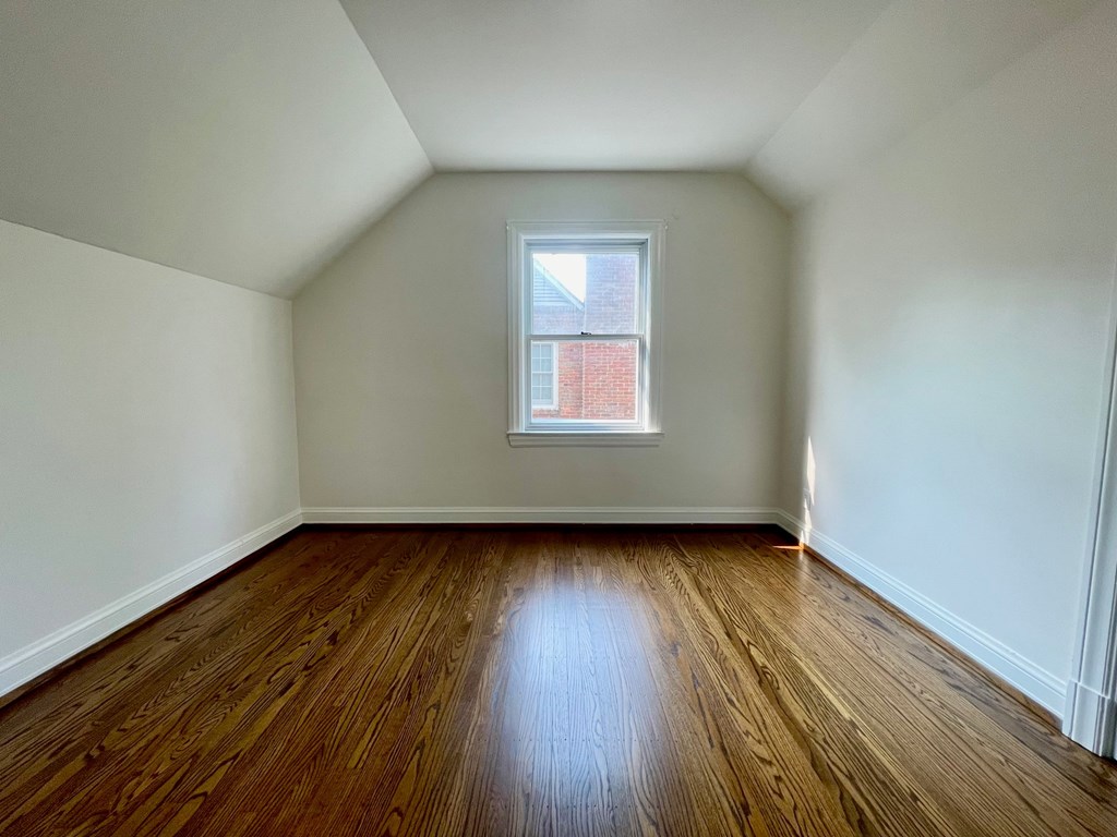 A room with wooden floors and a window.
