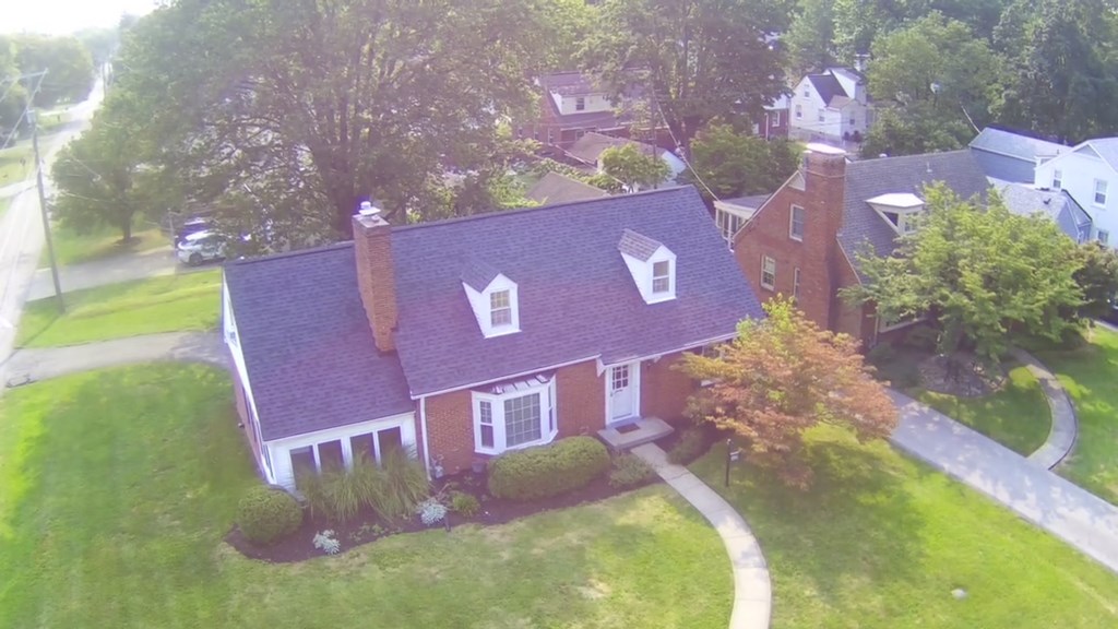 A red brick house with a white door and windows.