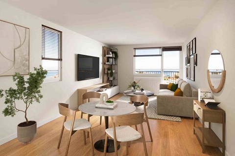 A living room with a table, chairs, and a television.