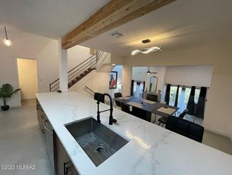 a large kitchen with a sink and a counter top