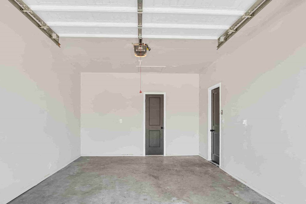 a empty room with a concrete floor and a door