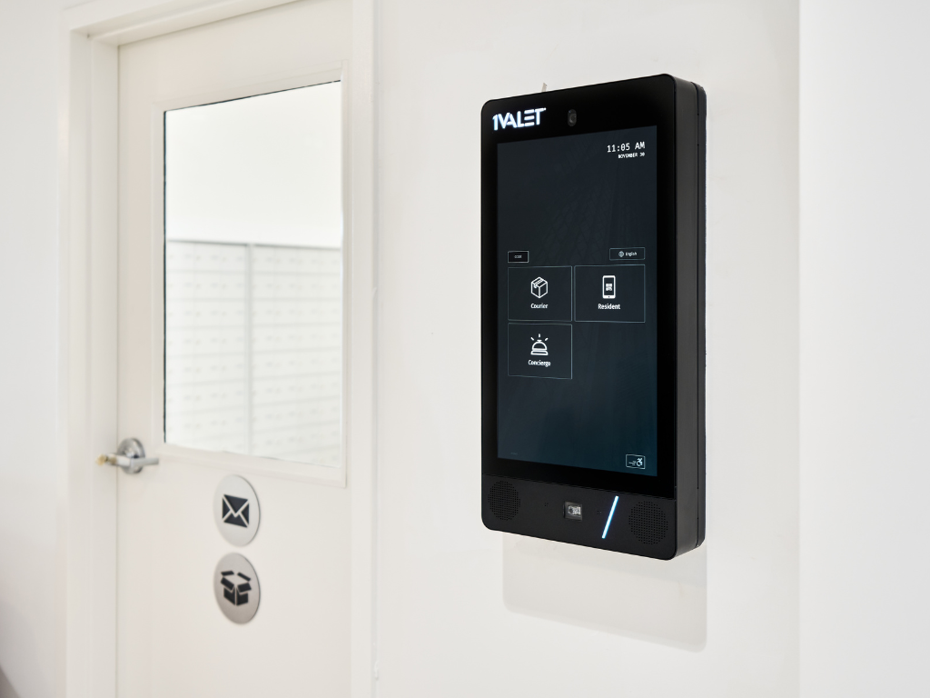 a smart thermostat on a wall next to a door