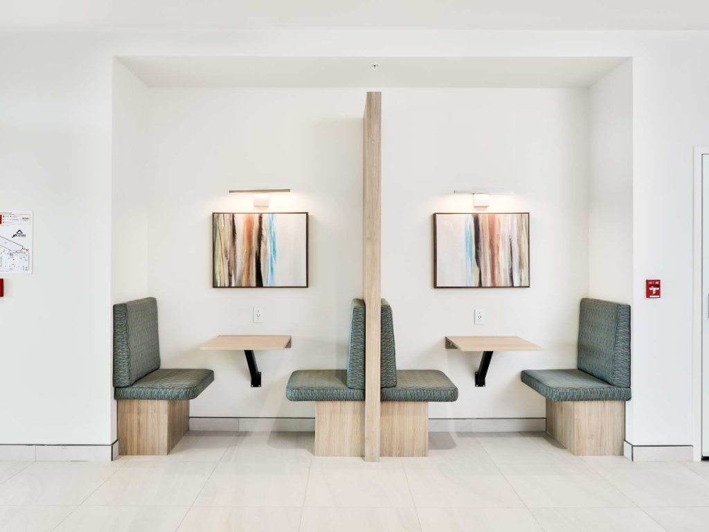 the waiting room of a hospital with chairs and tables