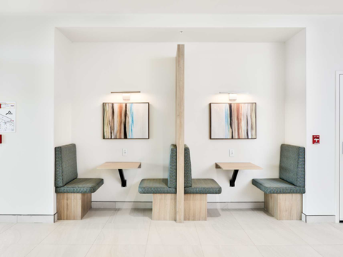 A white room with two tables and two chairs.