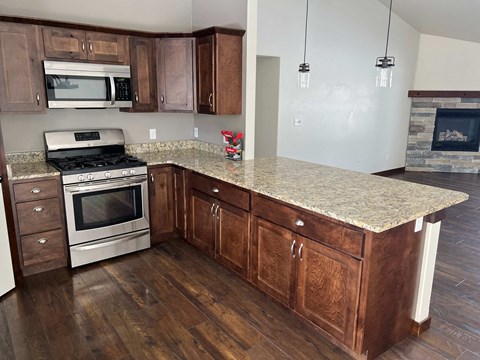 a kitchen with wooden cabinets and a granite counter top