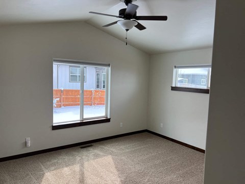 a living room with a ceiling fan and a window