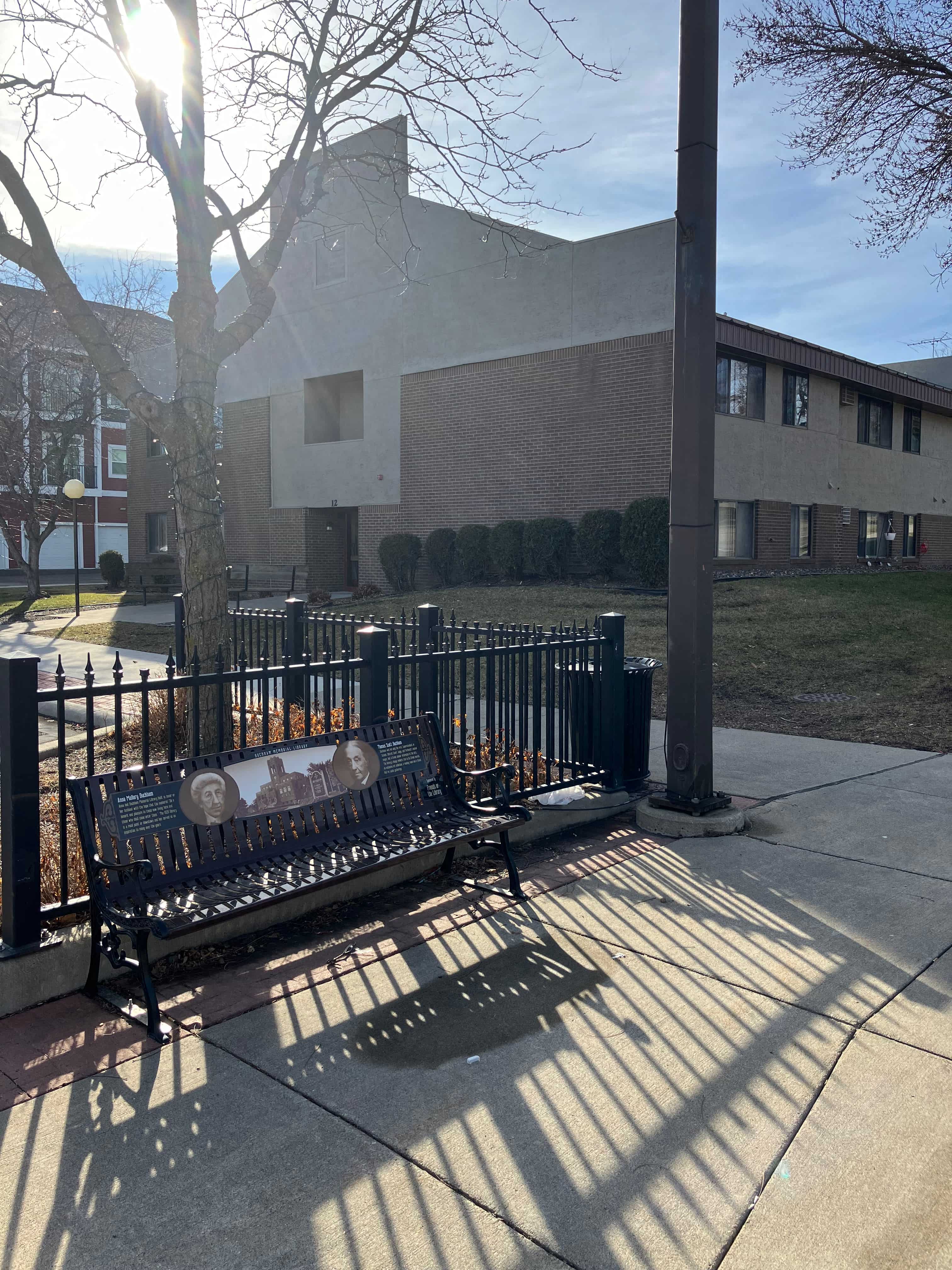 a park bench with a building in the background