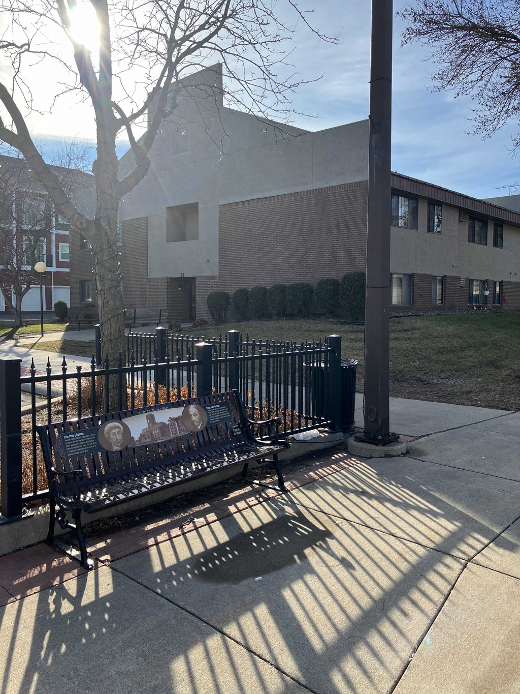 a park bench with a building in the background