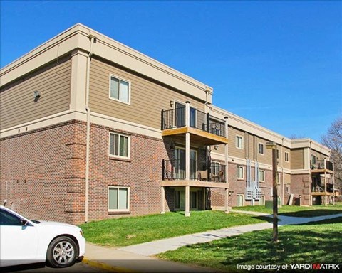 a white car parked in front of an apartment building