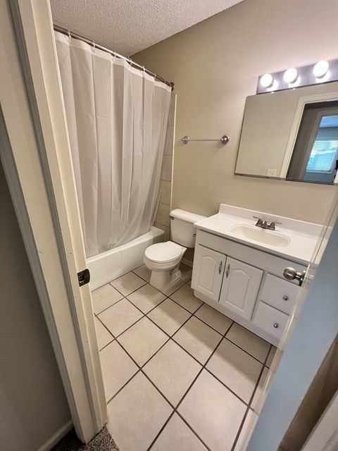 a bathroom with a sink toilet and a shower