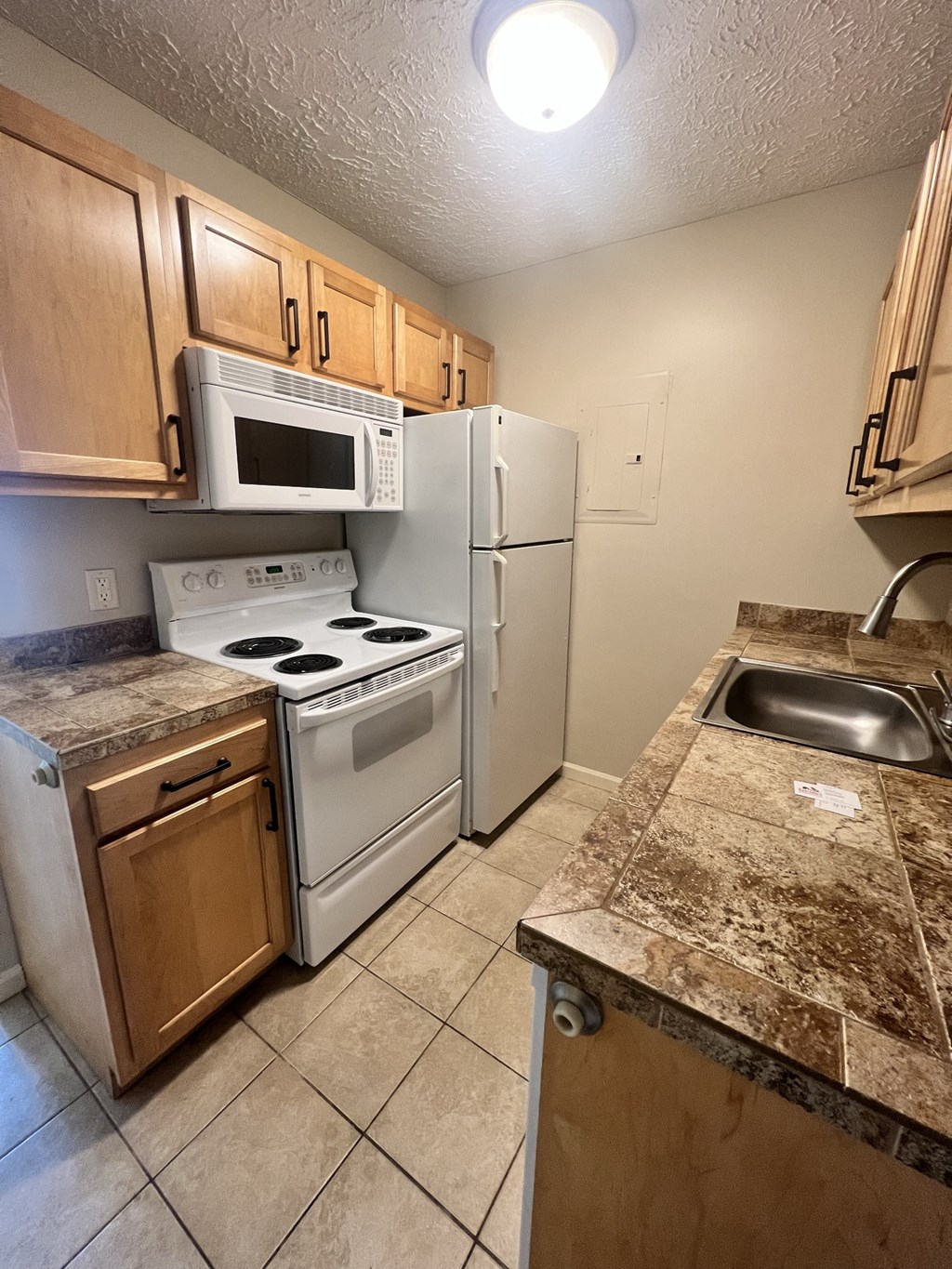 a kitchen with a stove microwave and refrigerator