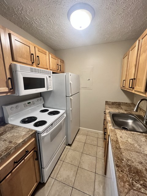 a kitchen with a stove microwave and refrigerator