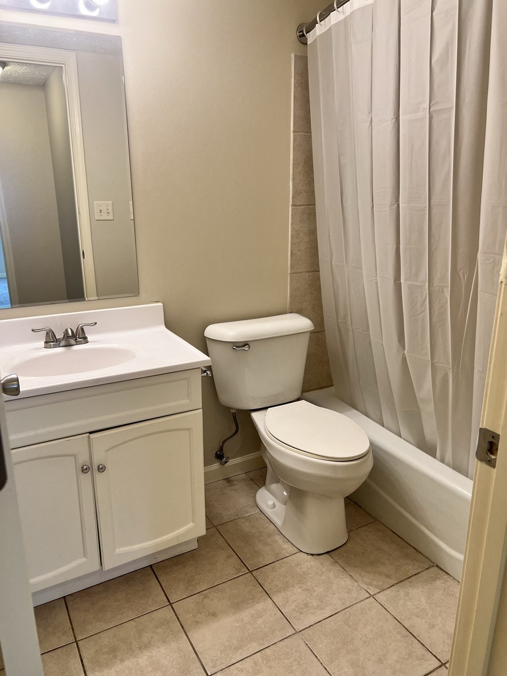 a bathroom with a toilet and a sink and a shower