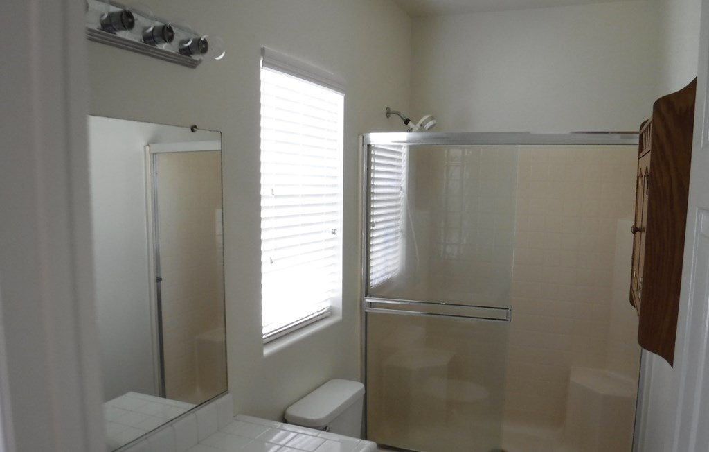 a small bathroom with a shower and a toilet