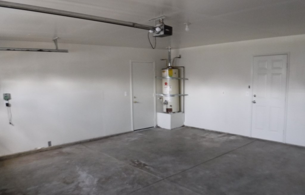 an empty garage with a white wall and a door