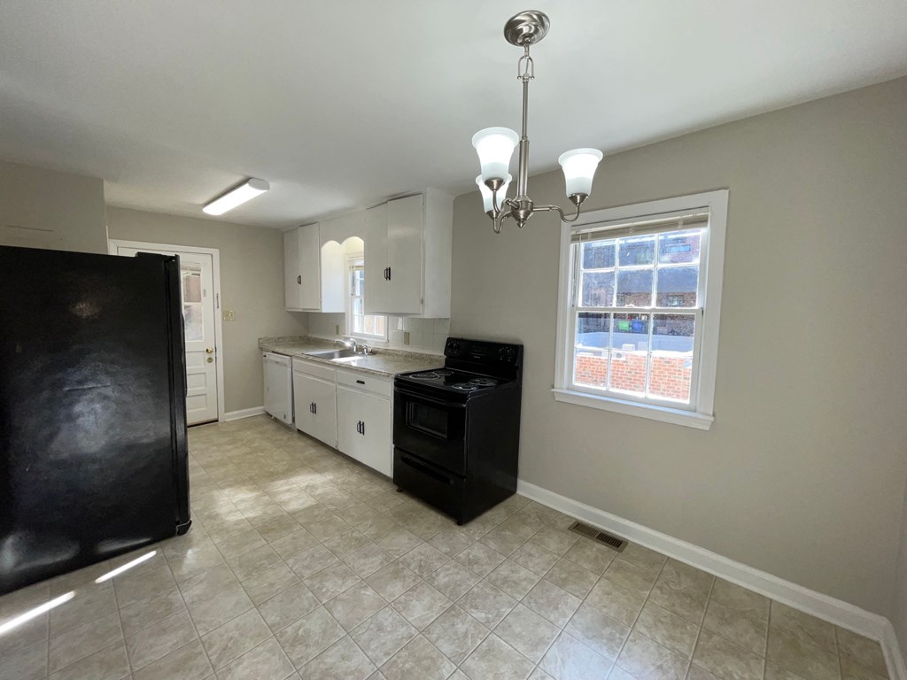 a kitchen with a black stove and a window