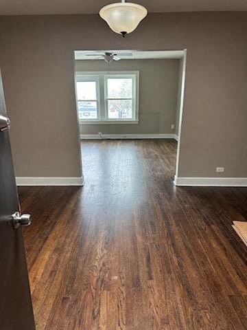 an empty living room with a hard wood floor