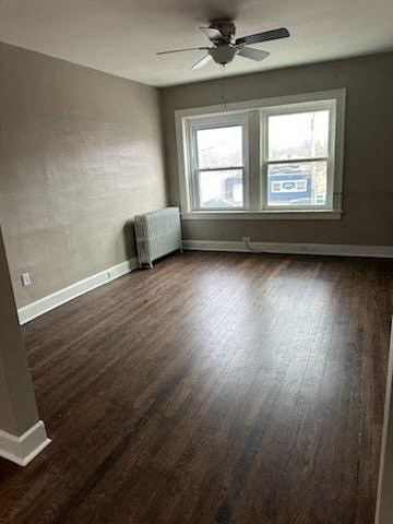 an empty room with a ceiling fan and a window