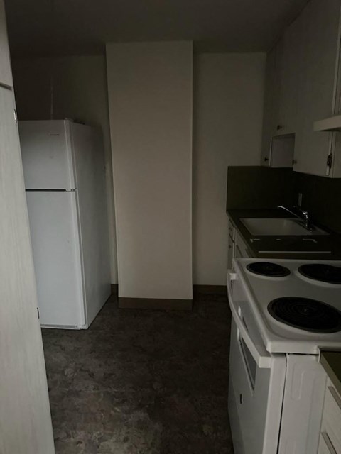 a kitchen with a stove and a refrigerator