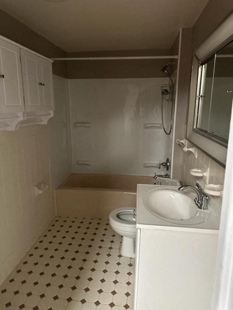 a white bathroom with a sink and a toilet