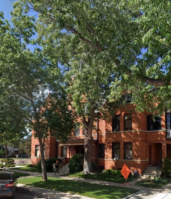 a red brick building with trees in front of it