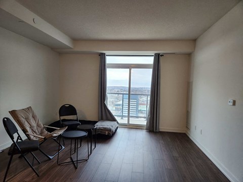 a living room with a table and chairs and a large window