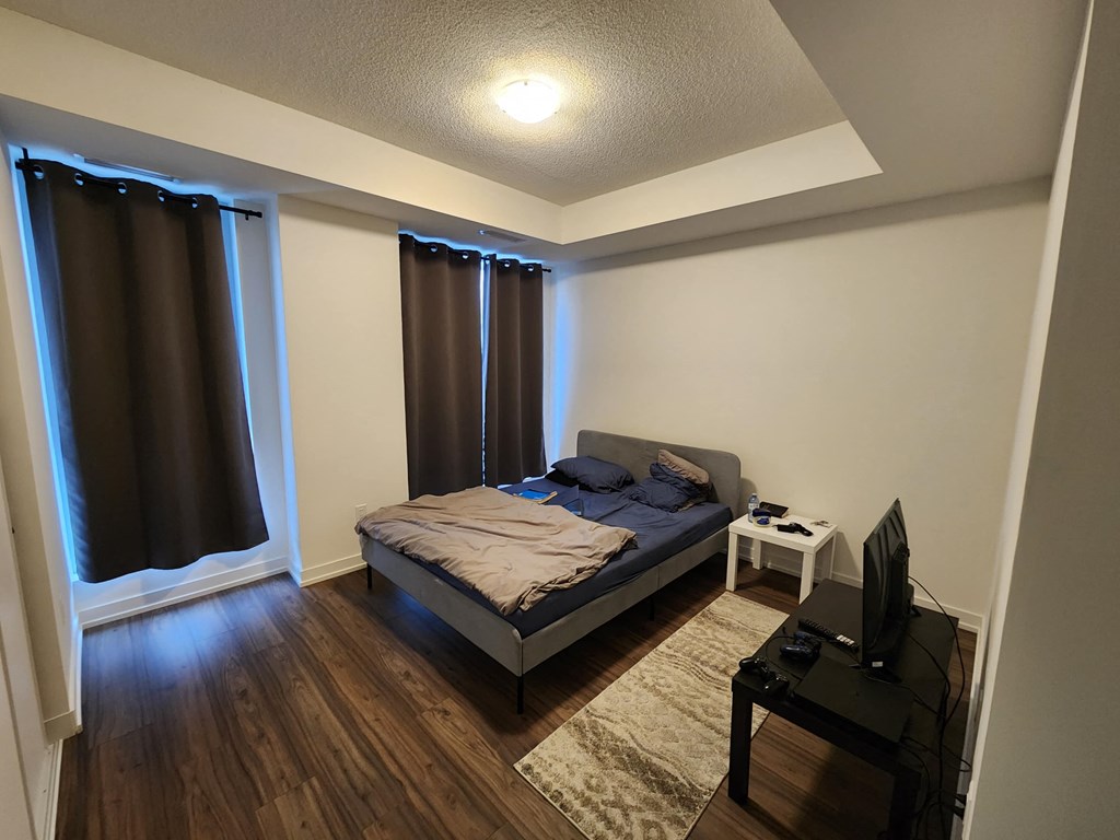 a bedroom with a bed and a tv
