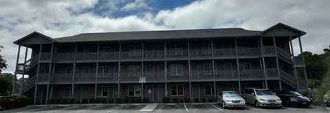 an old building with cars parked in front of it