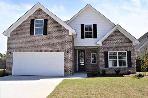 A two-story house with a garage door.