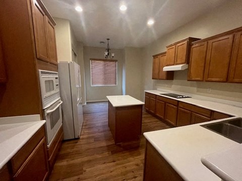 a kitchen with wooden cabinets and a refrigerator