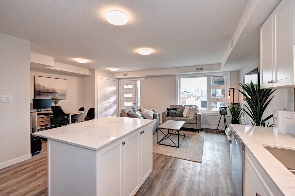 an open floor plan with an island kitchen and living room