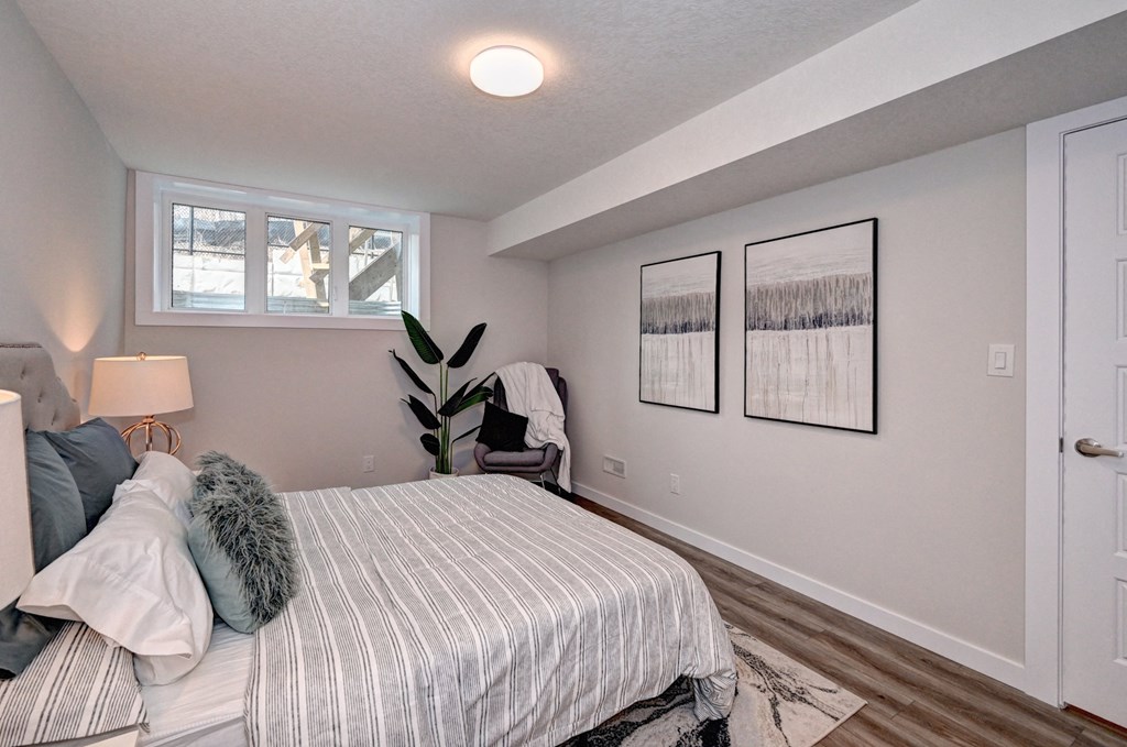 the master bedroom has a large bed and a window