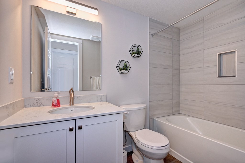 a bathroom with a sink toilet and a bath tub