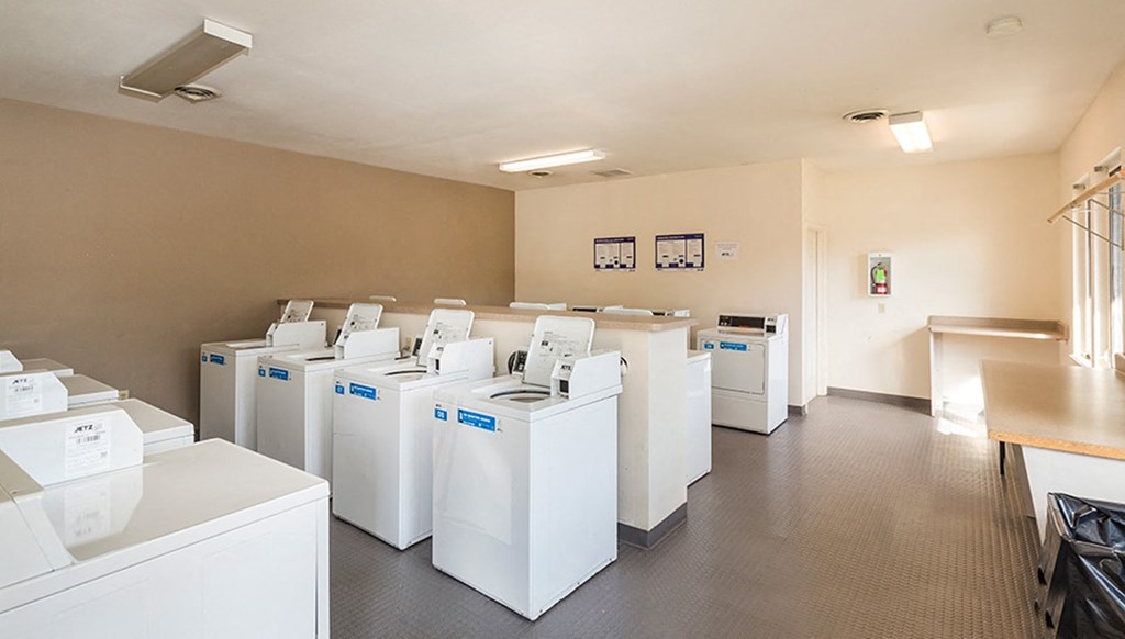 the laundry room is full of washes and dryers
