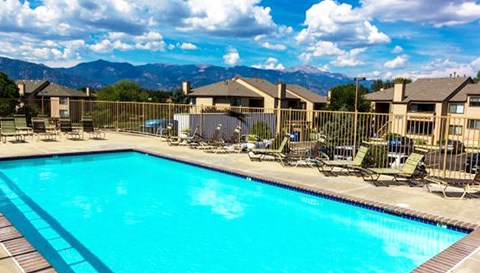 a large swimming pool with chairs around it