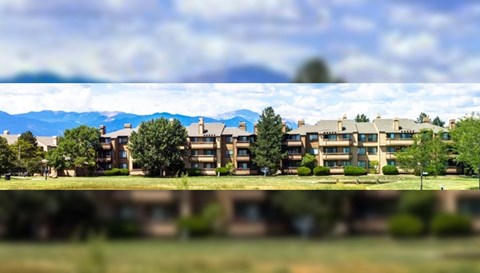 an image of an apartment building with mountains in the background