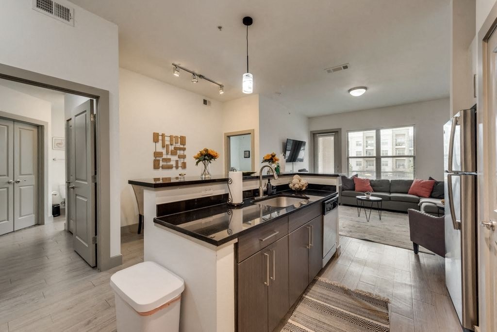 a kitchen and living room with a counter top