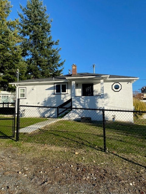 a small white house with a fence in front of it