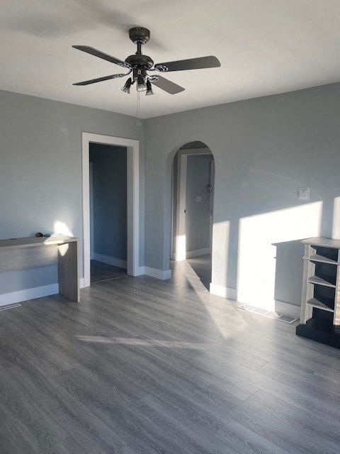 a empty living room with a ceiling fan