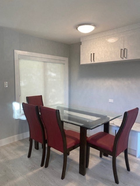 an empty dining room with a table and chairs