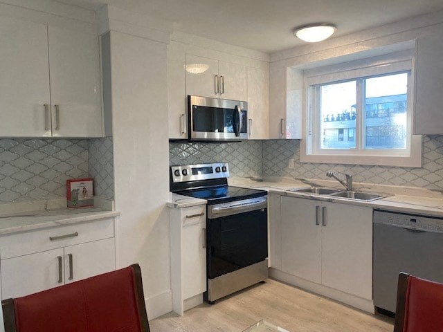 a kitchen with a stove and a sink and a window