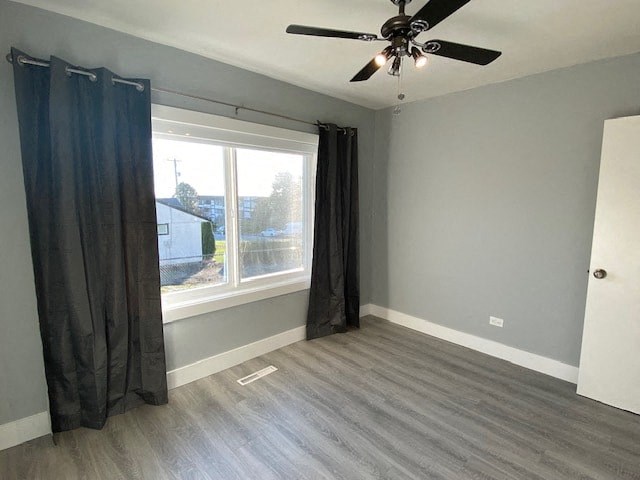 a living room with a ceiling fan and a window