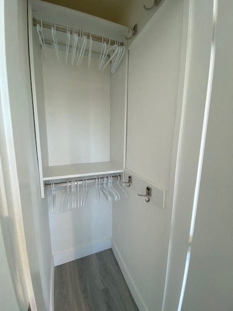 a white closet with white clothes hanging