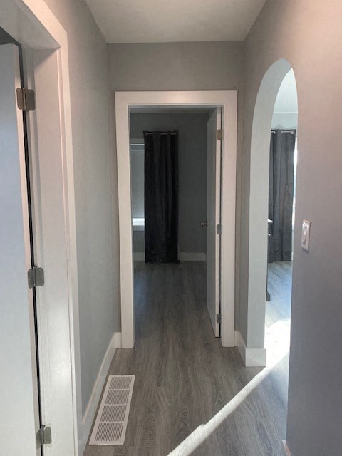 a hallway with a door to a bedroom and a hallway