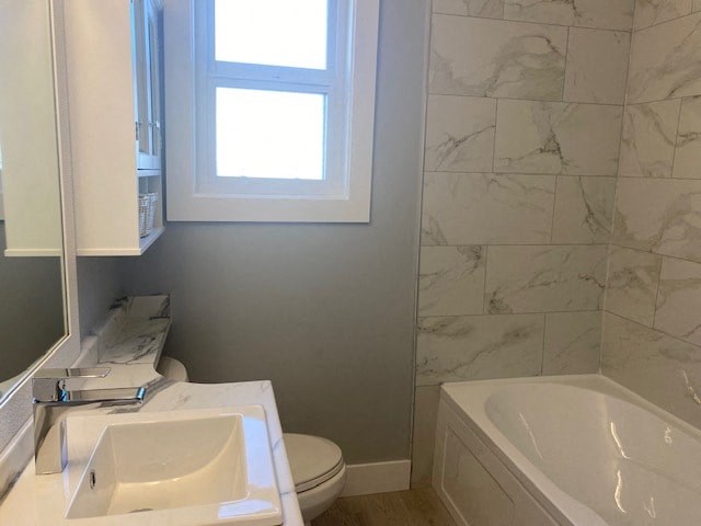 a bathroom with a toilet and a sink and a window