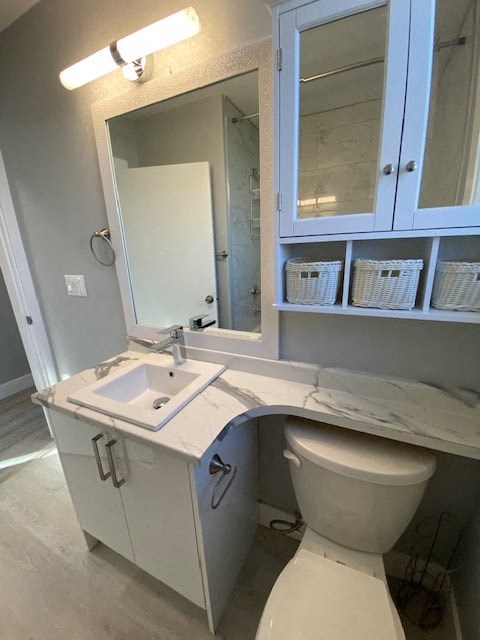 a bathroom with a toilet and a sink and a mirror