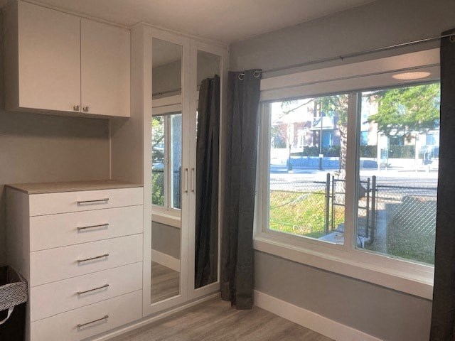 a kitchen with a large window and white cabinets
