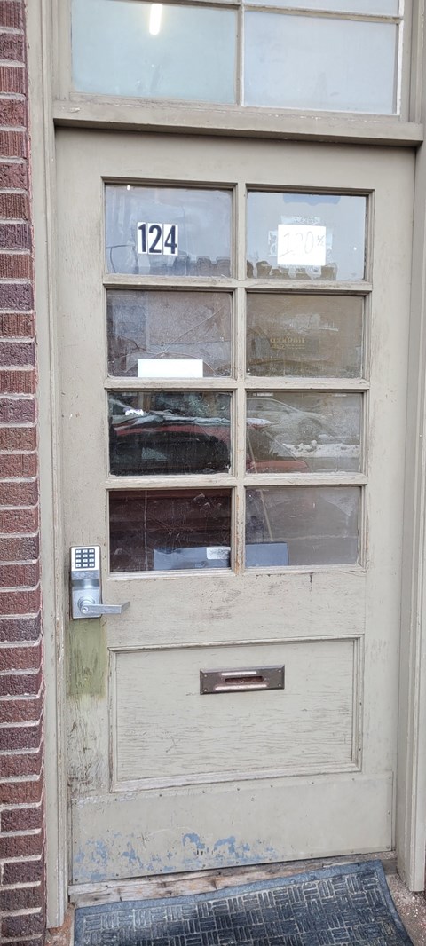 the front door of a building with a number 124 on it