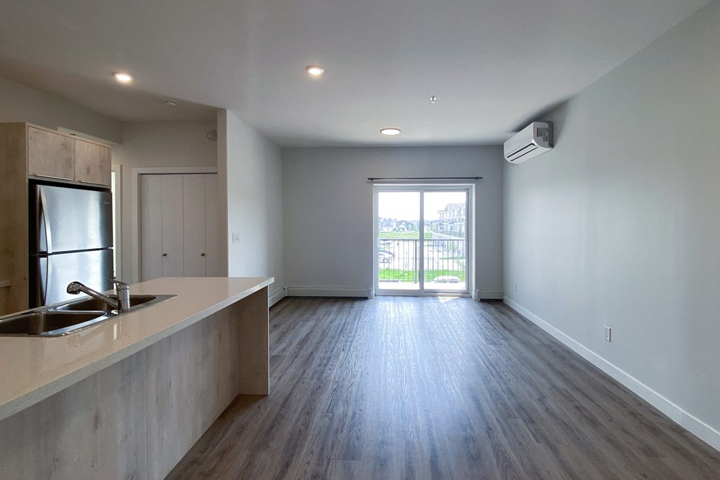 A kitchen with a sink and a refrigerator.